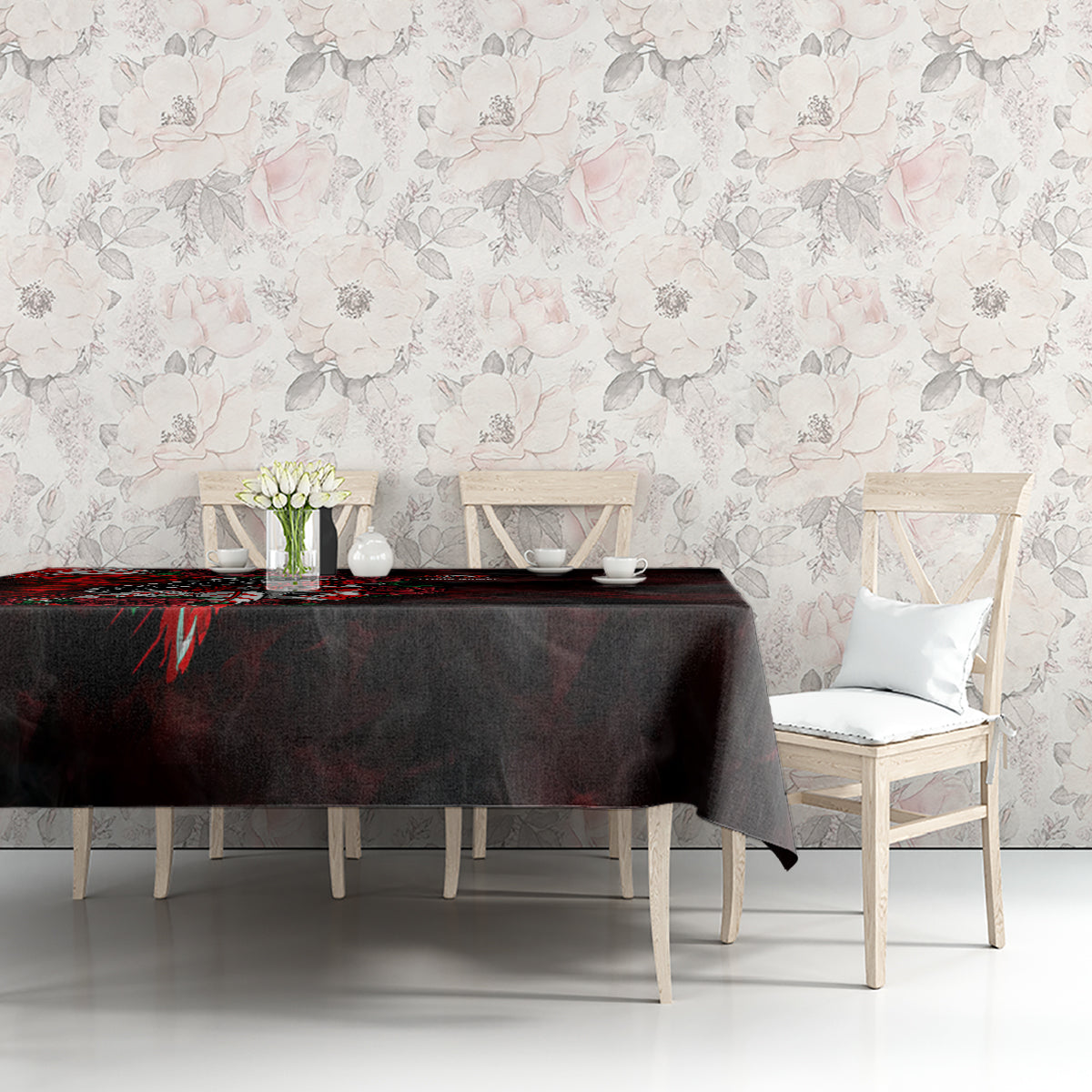 Black tablecloth with red skull and rose motif, laid across sofa-side table