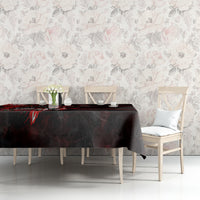 Black tablecloth with red skull and rose motif, laid across sofa-side table