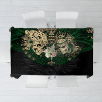 Black tablecloth with green Aztec skull and warrior graphic across center panel