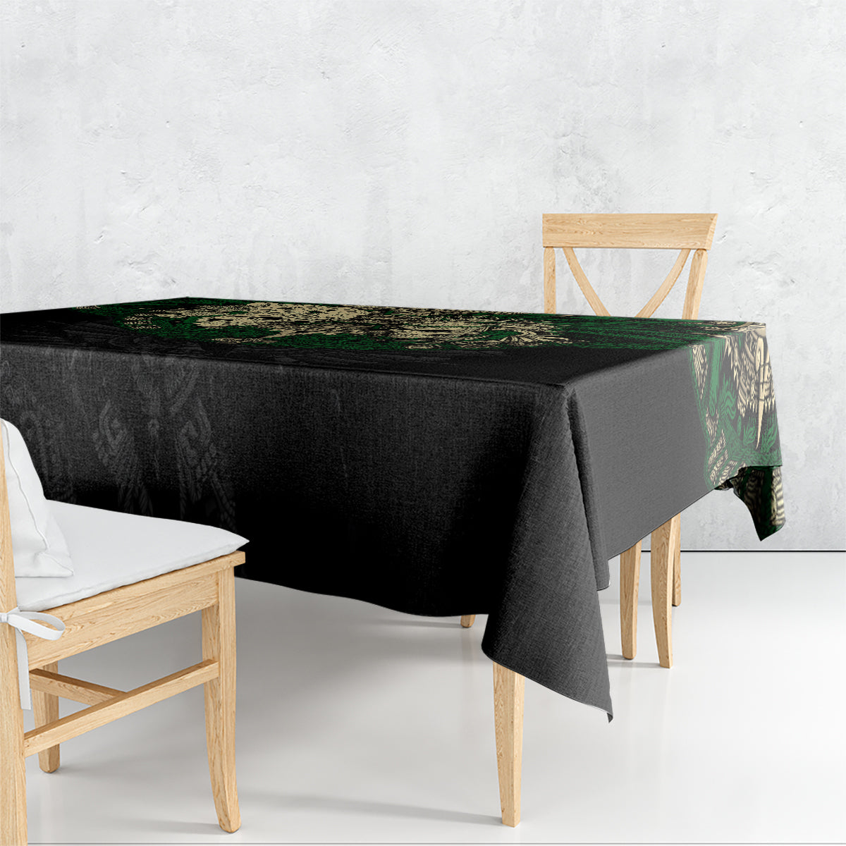 Black tablecloth with green Aztec skull warrior print draped over table edge