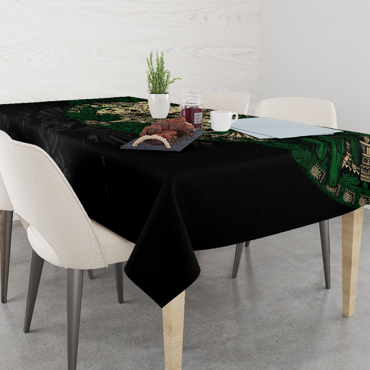 Black tablecloth with green Aztec skull warrior design and folded corner drop