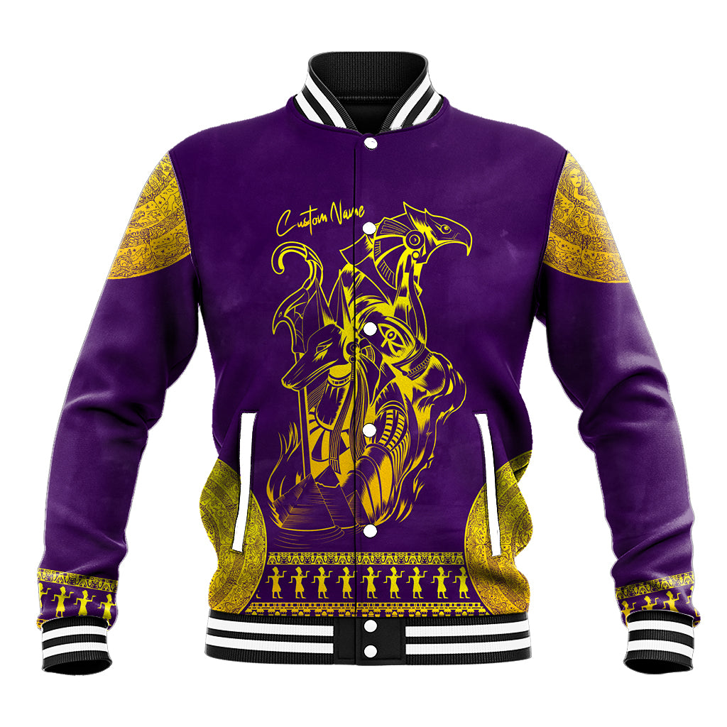 Purple baseball jacket with gold Egyptian animal graphic, striped ribbed collar and cuffs.