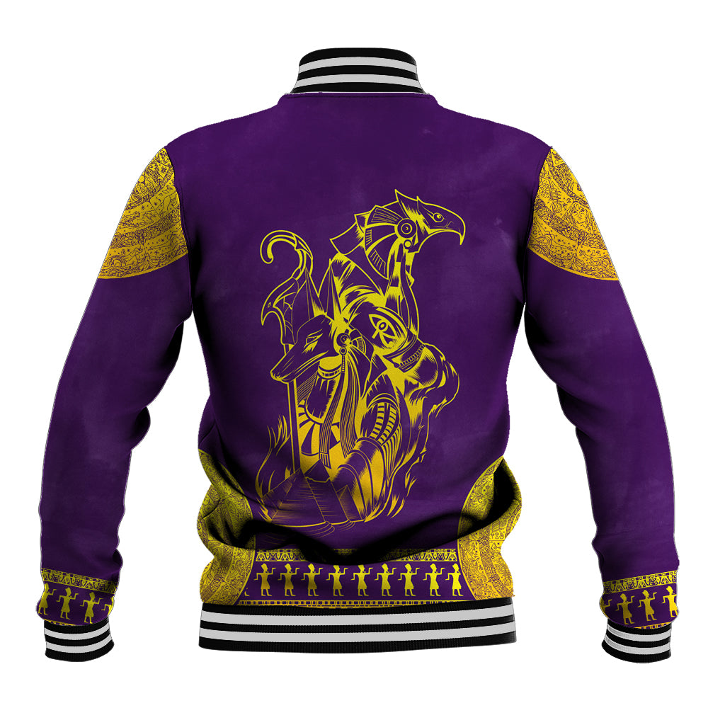 Purple baseball jacket with gold Egyptian back graphic, striped ribbed collar, hem and cuffs.