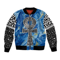 Blue bomber jacket with full-zip front, ankh emblem, and patterned black-and-white sleeves