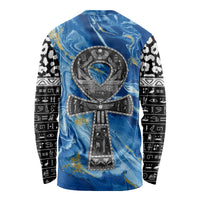 Blue long sleeve shirt with centered black ankh emblem and black-and-white patterned sleeves