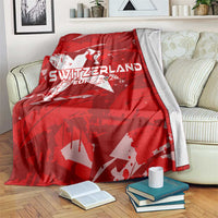 Red Switzerland football blanket draped over sofa, featuring star emblem and “EURO 2024”