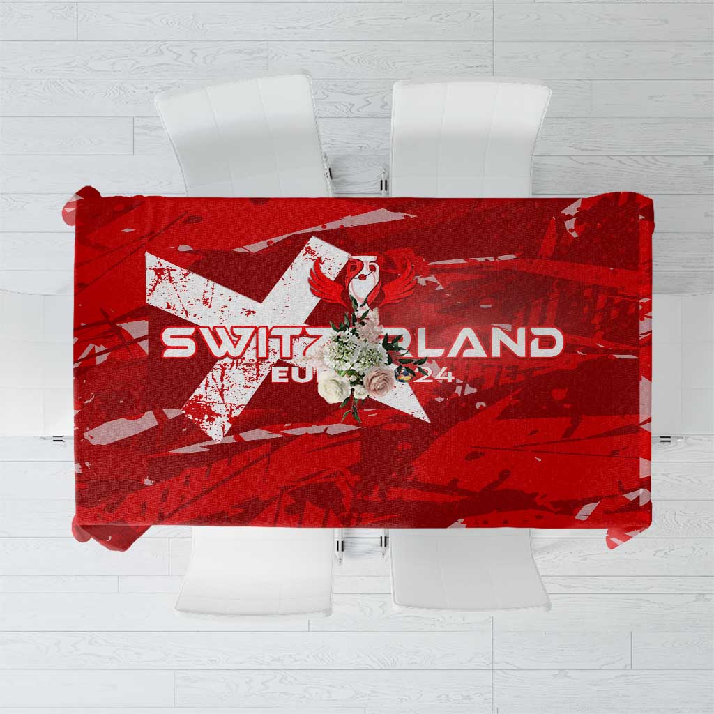 Red tablecloth featuring 'SWITZERLAND' text and soccer trophy-wing graphic print
