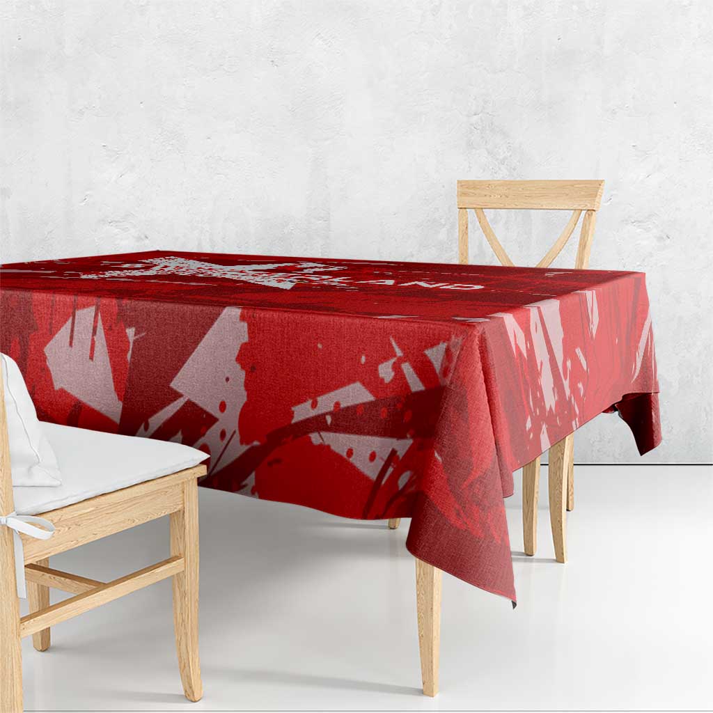 Red tablecloth draped over rectangular table with abstract star and wing pattern
