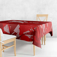 Red tablecloth draped over rectangular table with abstract star and wing pattern