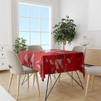 Red printed football-themed tablecloth with trophy-wing graphic design on tabletop