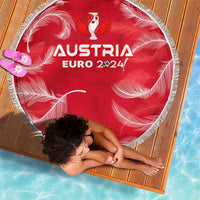Red round beach blanket with white fringe, Austria Euro 2024 print shown at angle