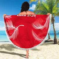 Red round beach blanket with white fringe, Austria Euro 2024 print held on beach