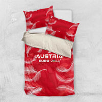 Red duvet cover with AUSTRIA EURO 2024 print and white feather design, shown flat with pillows