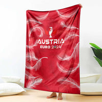 Red Austria Euro 2024 blanket with white feather pattern and central trophy logo