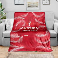 Red Austria Euro 2024 blanket with centered trophy wing logo and swirling feather print