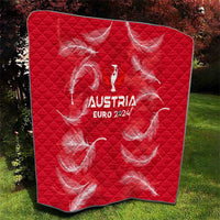 Red quilt blanket with diamond quilting, Austria Euro 2024 logo, white feather graphics