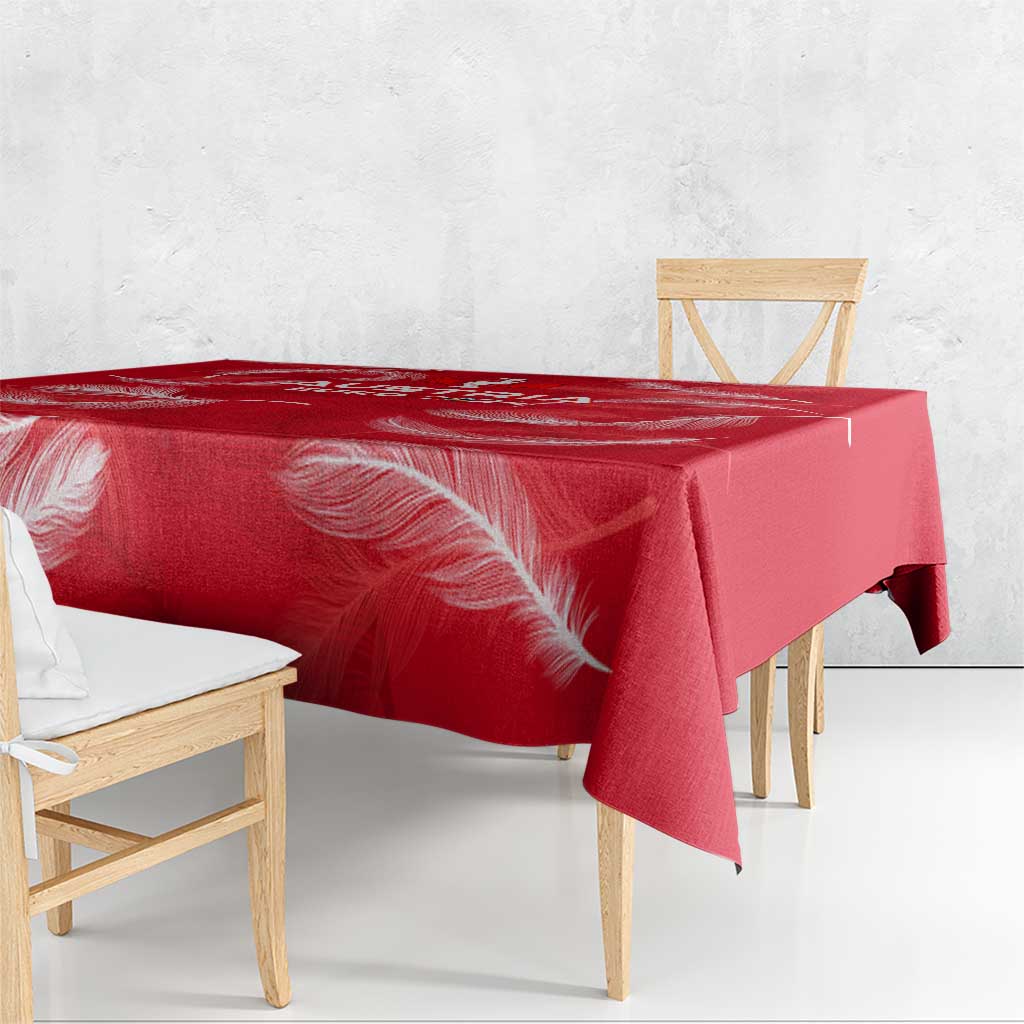 Red tablecloth with white feather graphic, draped over table edges
