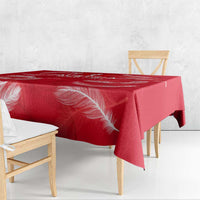 Red tablecloth with white feather graphic, draped over table edges