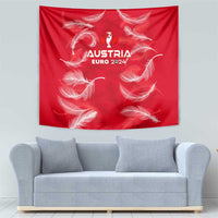Red wall tapestry with white feather pattern and Austria Euro 2024 crest above sofa