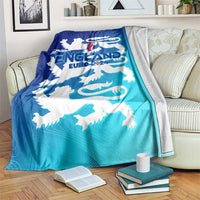 England football blanket draped over couch, blue/teal gradient with white lion crest
