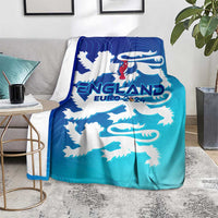 England football blanket on chair, blue/teal gradient with white lion crest and 'EURO 2024'