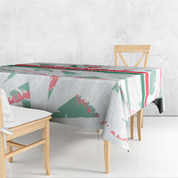 White tablecloth draped over dining table with green and red graphic stripes