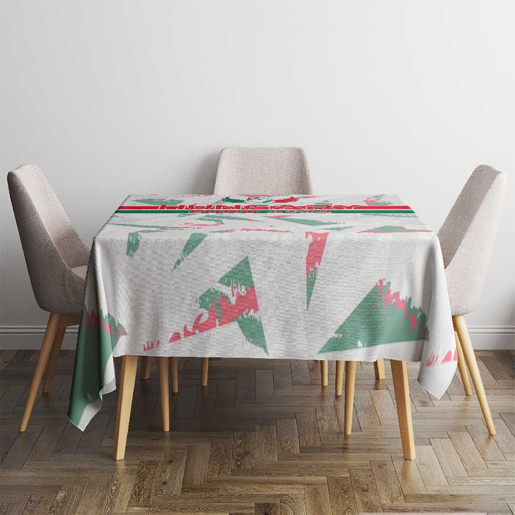 White round-edge tablecloth with green and red graphic print on dining table