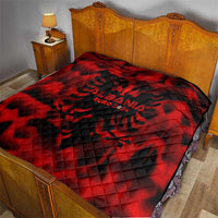 Red quilt blanket on bed with black Albania EURO 2024 emblem design