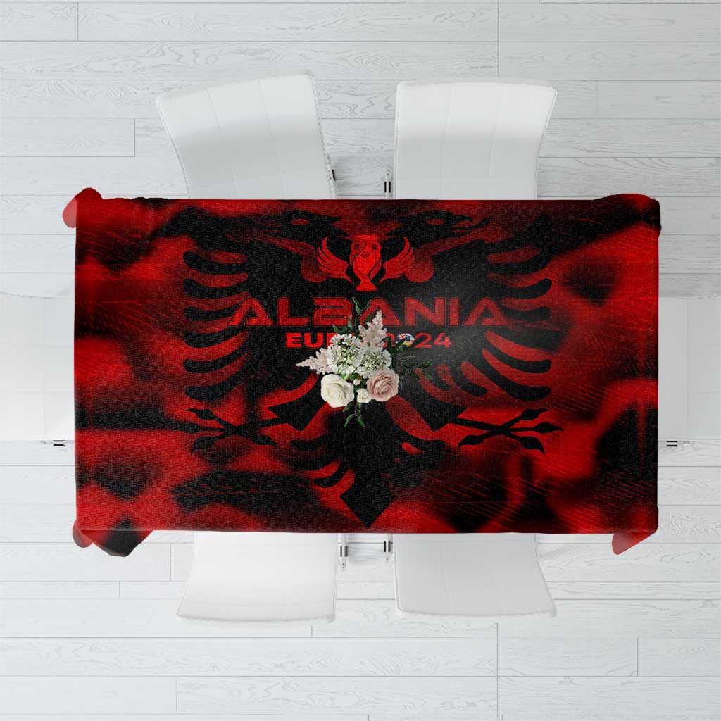 Red tablecloth with black Albanian eagle and wing crest design, laid flat
