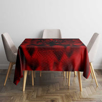 Red tablecloth with black wing pattern, spread on a square table with chairs