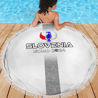 White circular beach blanket with fringe, SLOVENIA EURO 2024 logo on wooden deck