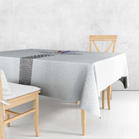 White tablecloth draped over dining table corners, with dark patterned center stripe