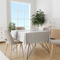 White tablecloth on dining table with patterned center stripe panel