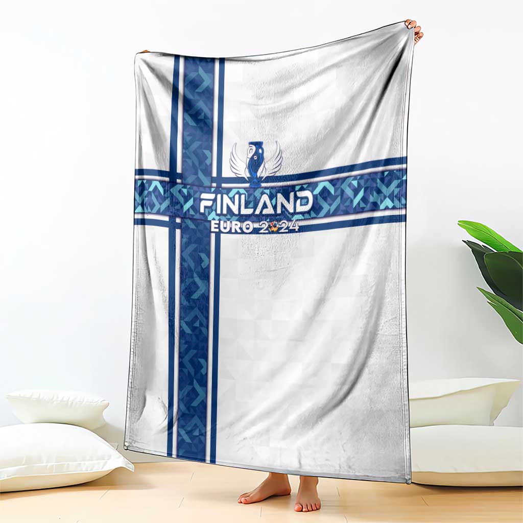White blanket with blue vertical cross stripes, Finland crest and Euro 2024 banner