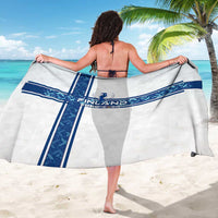 White sarong with navy cross stripes and Finland crest, held wide