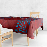 Red tablecloth with blue geometric pattern, corner drop on wooden dining table