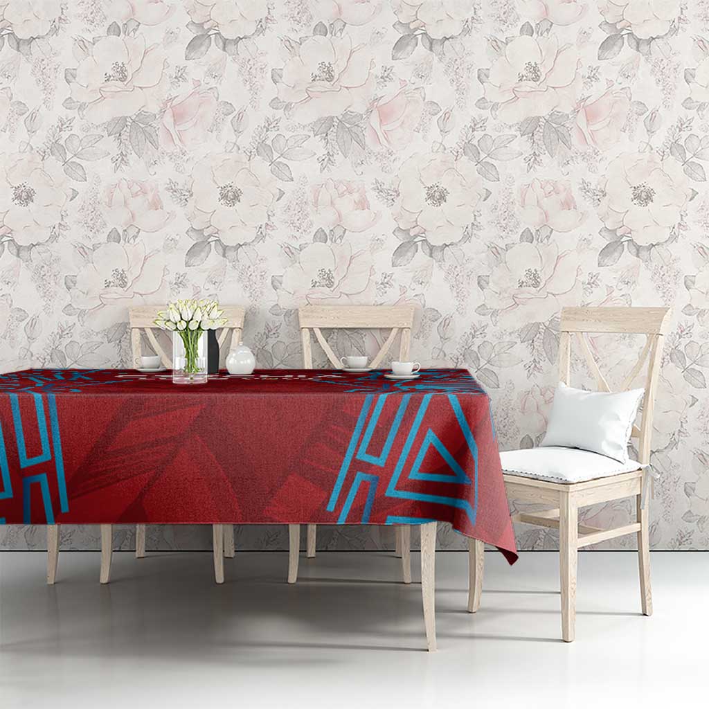 Red football-themed tablecloth with blue geometric pattern, draped across dining table