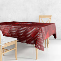 Red tablecloth with all-over geometric pattern and draped edge