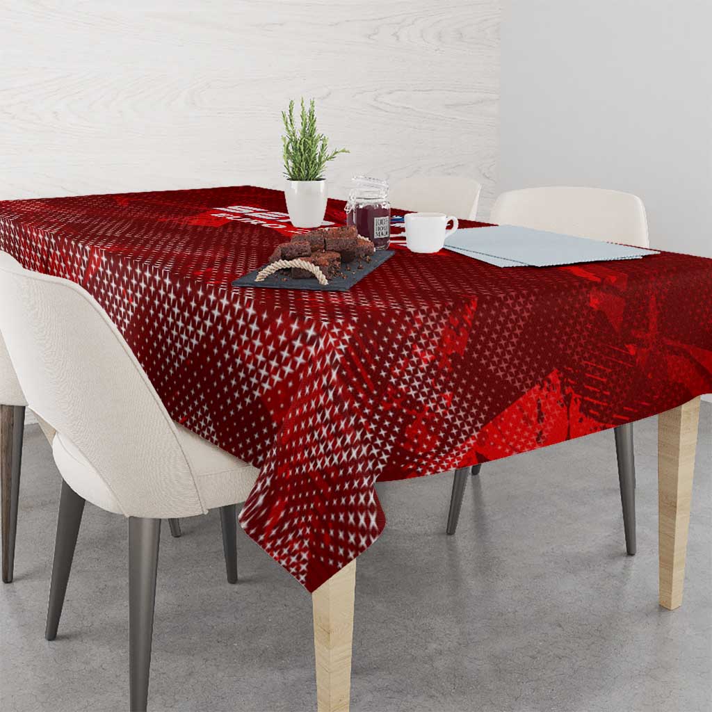 Red patterned tablecloth with central graphic near the table center