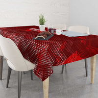 Red patterned tablecloth with central graphic near the table center