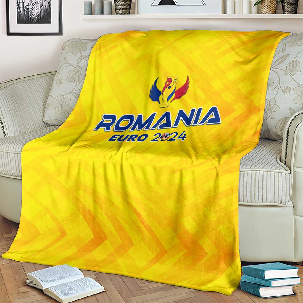 Yellow Romania Euro 2024 blanket with crest logo, draped over armchair