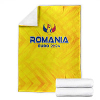 Yellow Romania Euro 2024 blanket with crest logo, folded with white towels