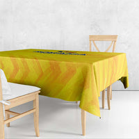 Yellow football tablecloth draped over rectangular table, crest logo near top edge