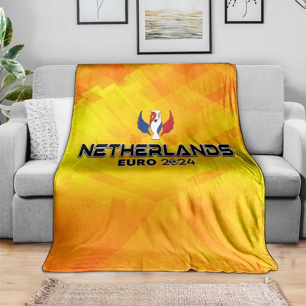 Yellow Netherlands Euro 2024 blanket with trophy wing print draped on gray sofa