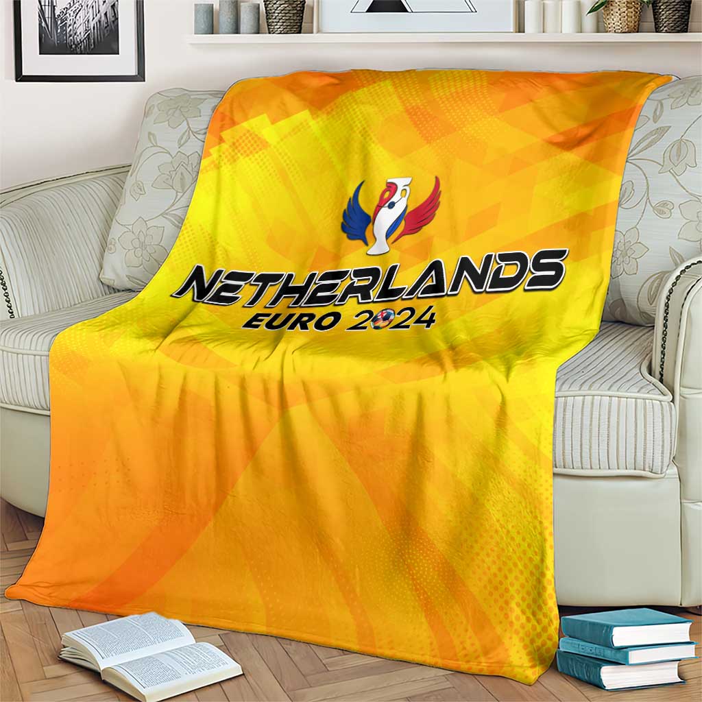 Yellow Netherlands Euro 2024 blanket with trophy wing logo and text on sofa