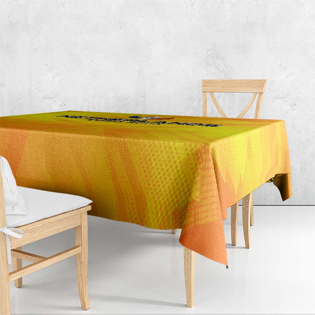 Yellow and orange football tablecloth with patterned finish on wooden table