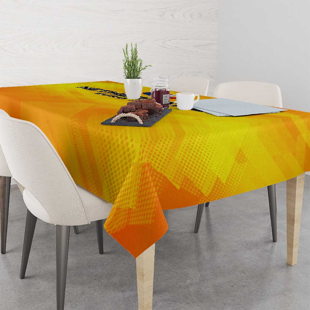 Yellow football tablecloth on dining table with cutlery and small center items