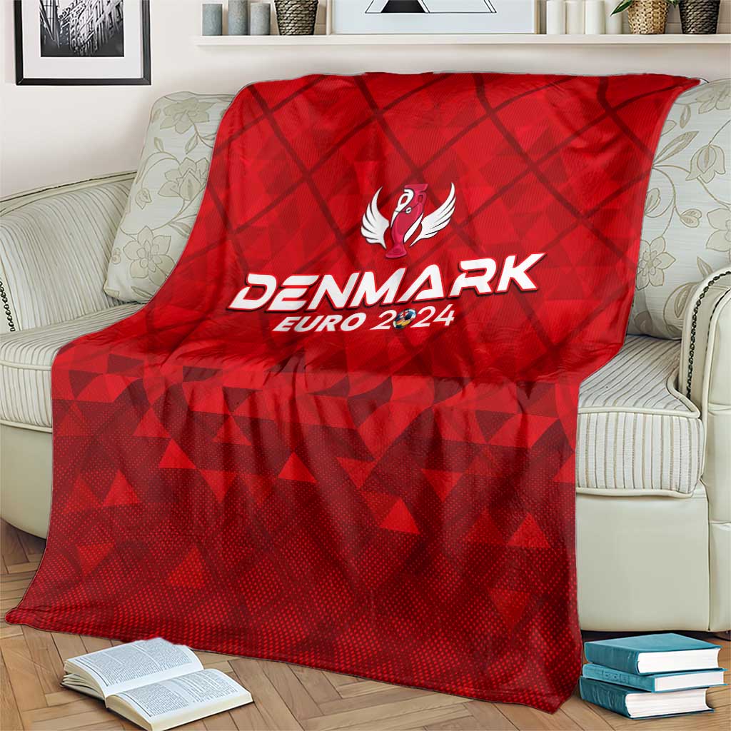 Red Denmark football blanket covering sofa, trophy wing emblem and EURO 2024 lettering