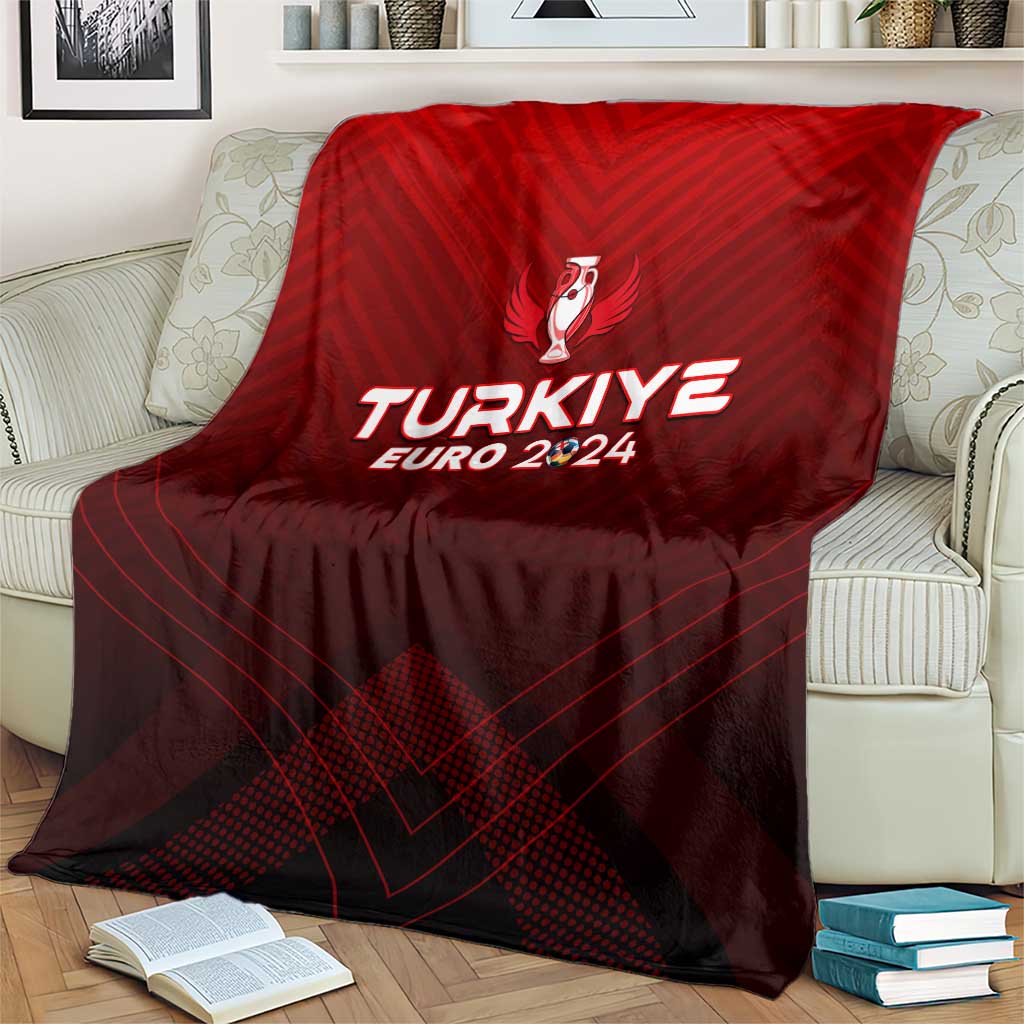 Red football blanket draped over armchair, showing trophy crest and TURKIYE EURO 2024 print
