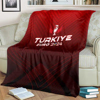 Red football blanket draped over armchair, showing trophy crest and TURKIYE EURO 2024 print